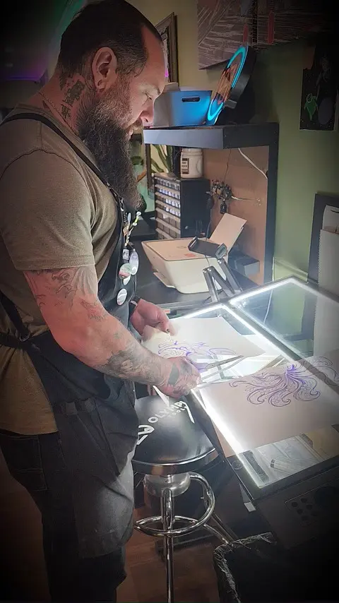 Jesse developing an original tattoo design at the studio